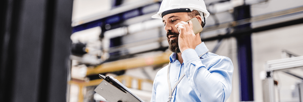Worker Speaking on Phone About Press Machine Hydraulic System