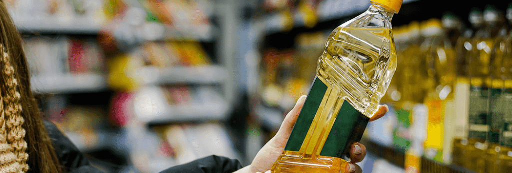 Hand Holding Bottle of Oil Extracted From Expeller Oil Press/Oil Expeller Machine