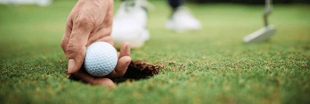 Man Placing Golf Ball on Ground Made From Hydraulic Press Machine
