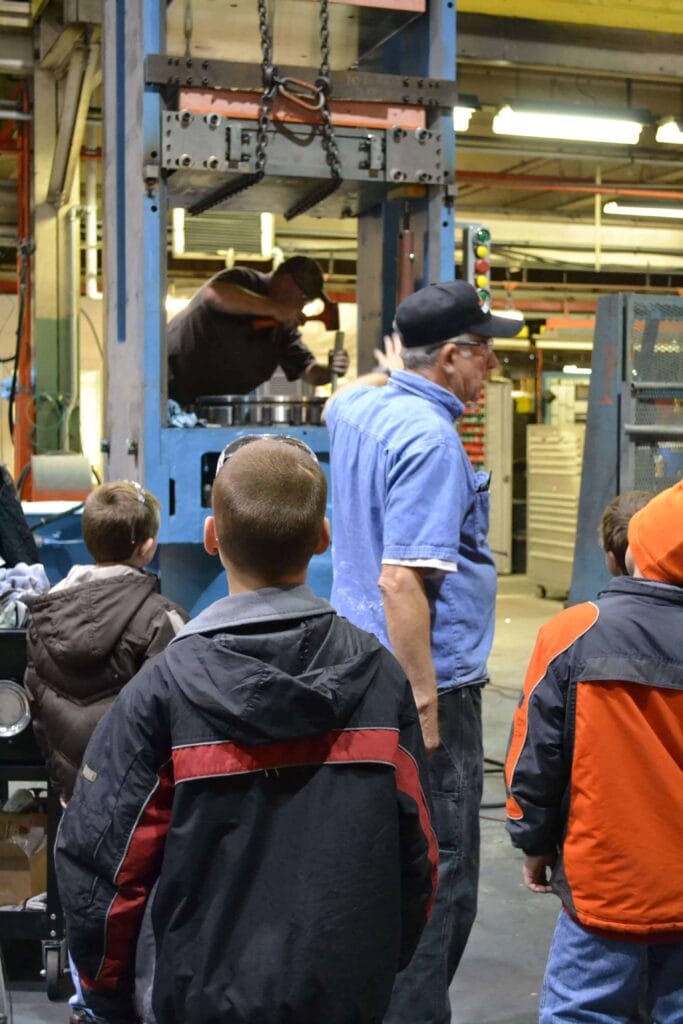 Workers Showing Students Hydraulic Pressesz