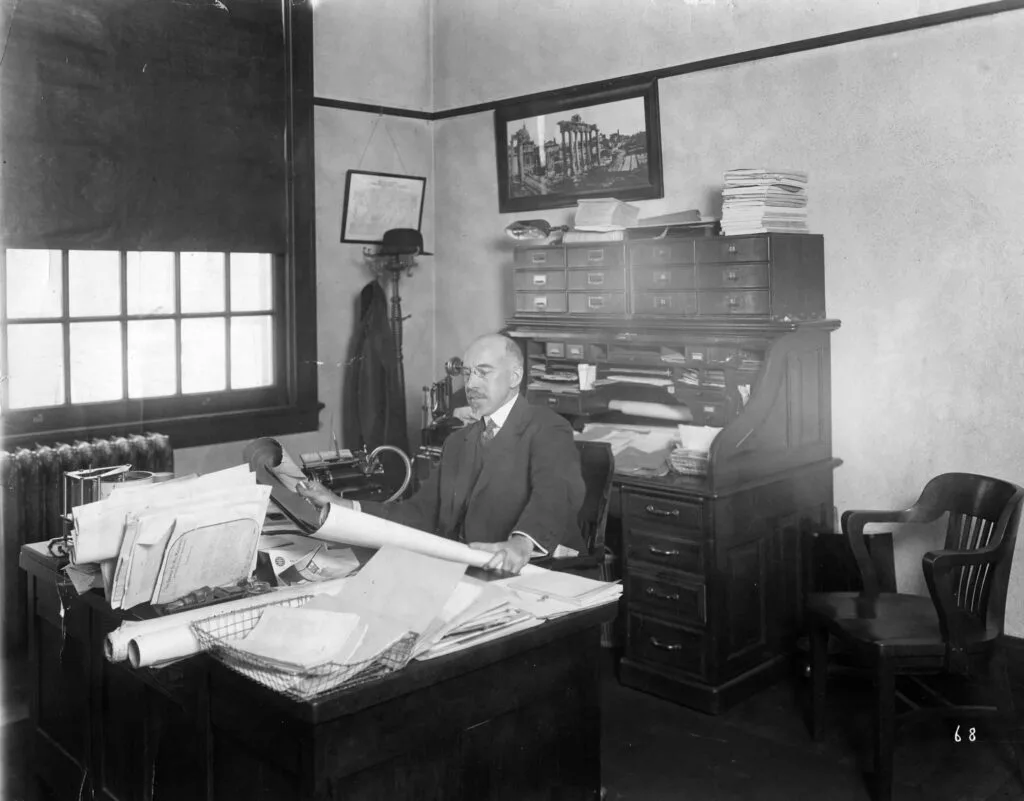 French Oil Mill Machinery Company Incorporated Owner Looking at Rolled Paper