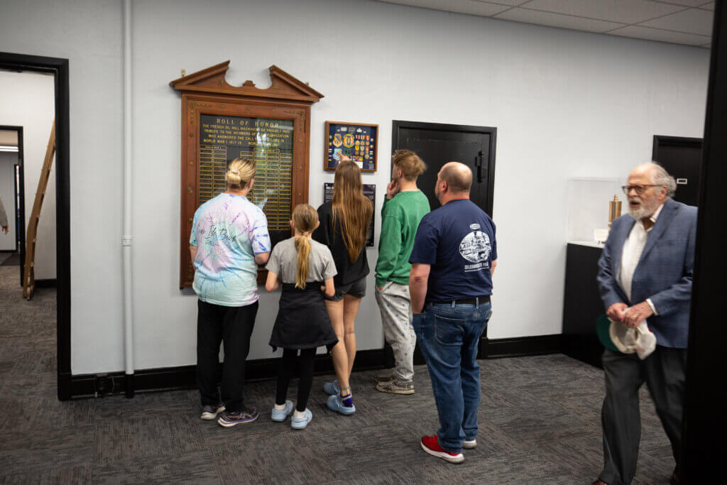 People looking at the Roll of Honor dedication in the French History Museum.