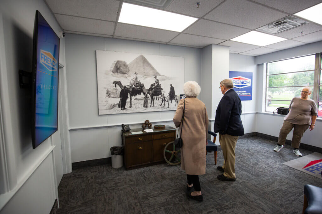 People looking at a photo of Egypt in the French Lobby.