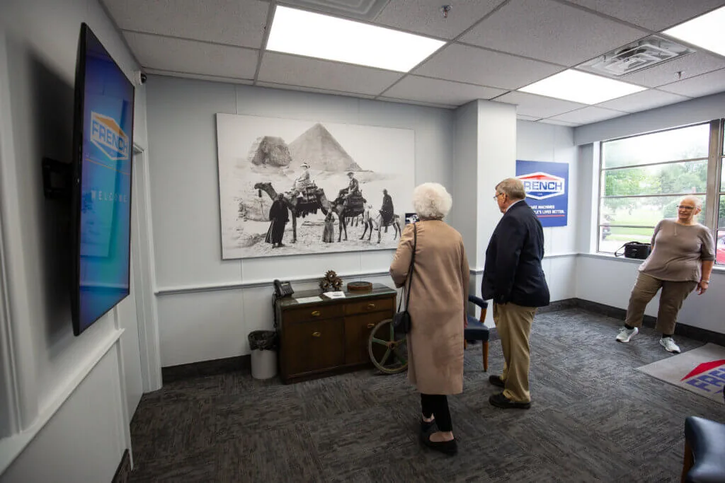 People looking at a photo of Egypt in the French Lobby.