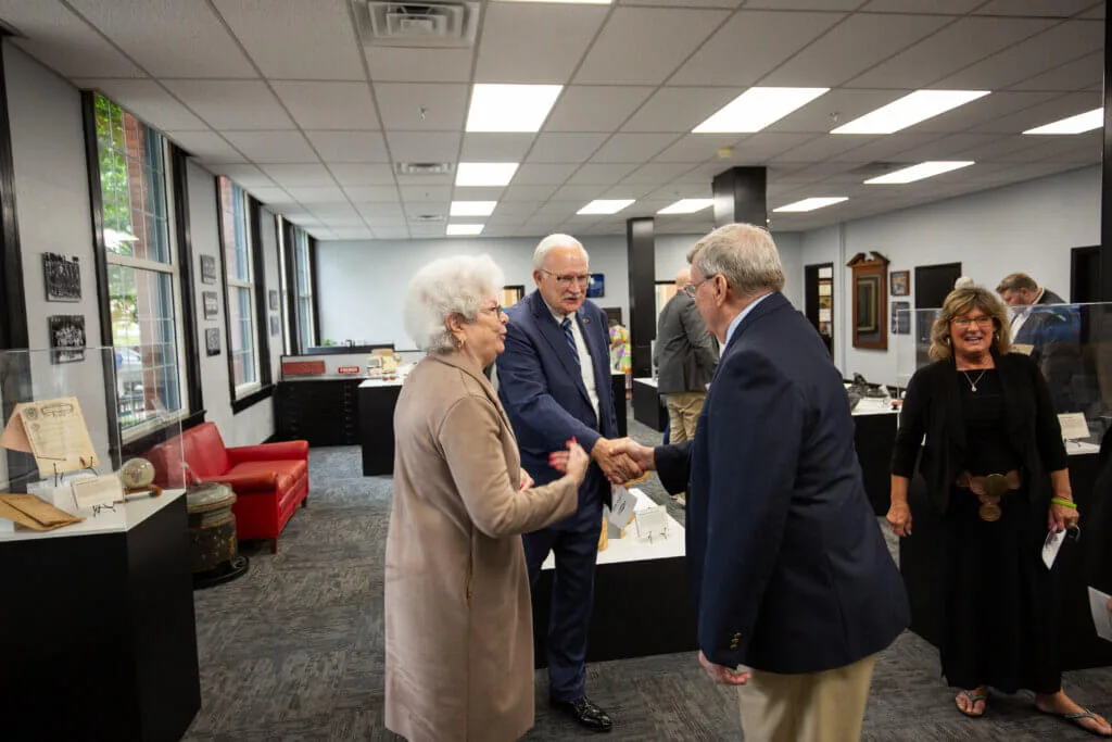 People meeting in the museum at French Oil.
