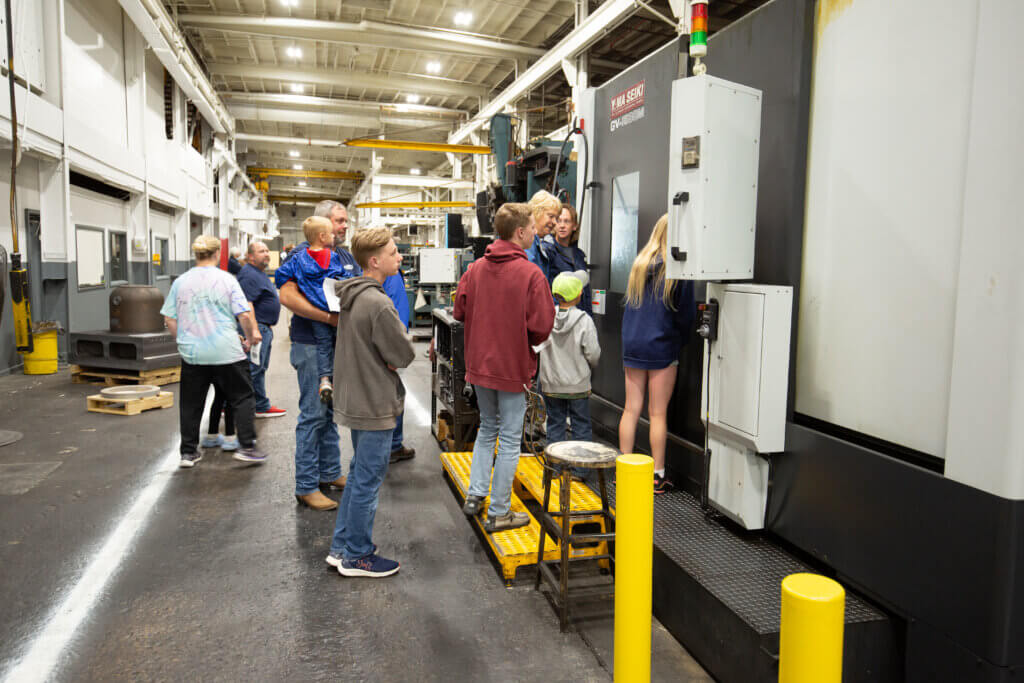 Guests looking into a CNC machine.