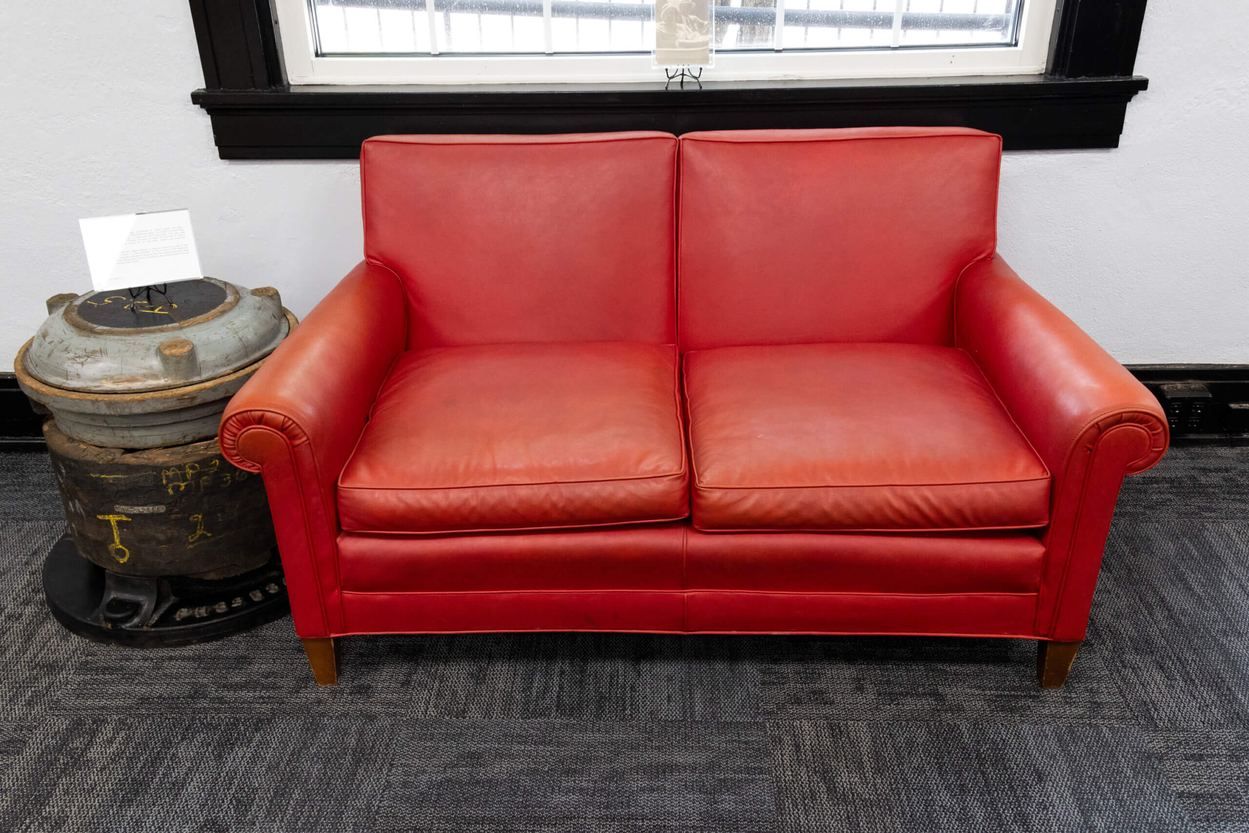 loveseat_in_lipstick_red_french_museum Mid-century loveseat in lipstick red upholstery, a gift from Marjorie French to Alfred W. French Jr., in The French Museum.