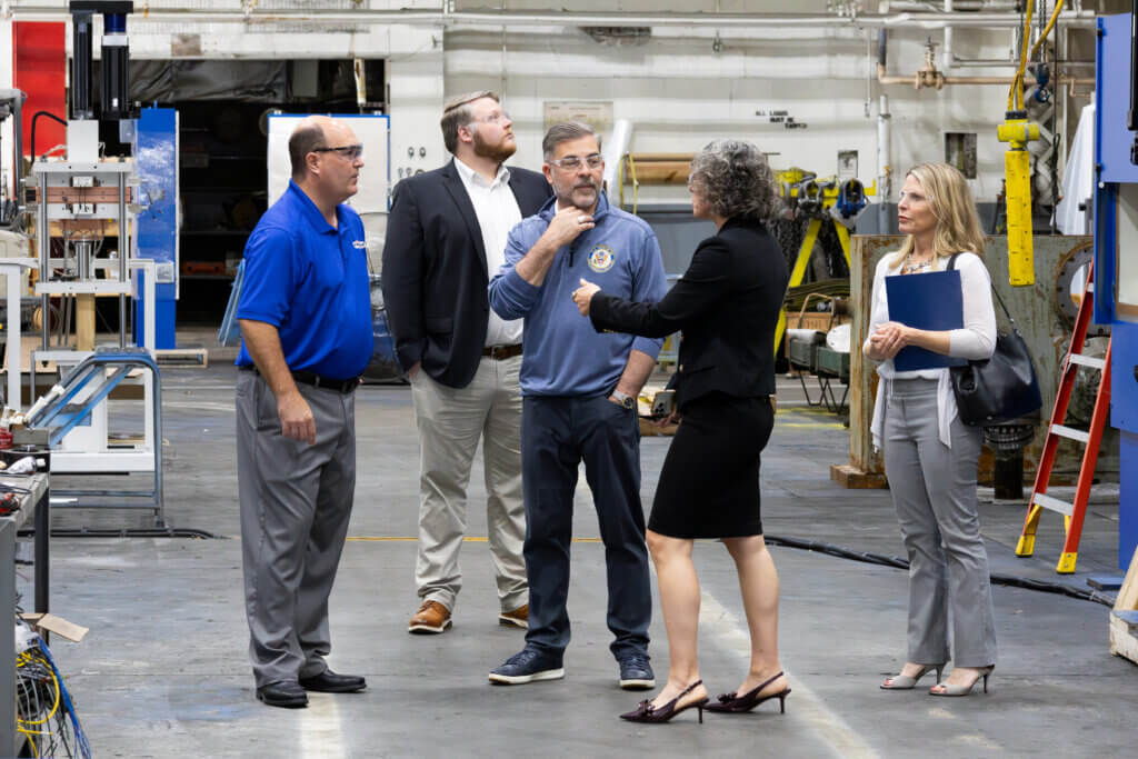 Individuals having a conversation while standing in a French Headquarters