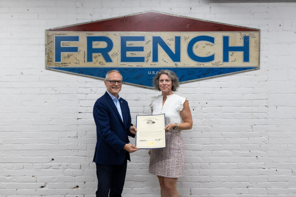 Representative Johnathan Newman stands with Tayte French Lutz, CEO and Chairman of The French Oil Mill Machinery Company, inside the company’s headquarters during a 125th anniversary visit.